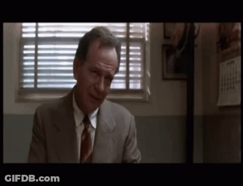 Man In Suit And Tie Sitting By Window GIF