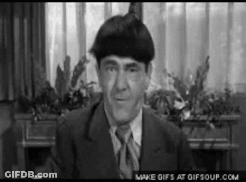 Man In Suit And Tie Sitting By Window GIF