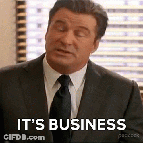 Man In Suit And Tie Sitting By Window GIF