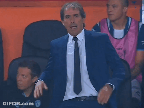 Man In Suit And Tie Sitting In Chair GIF