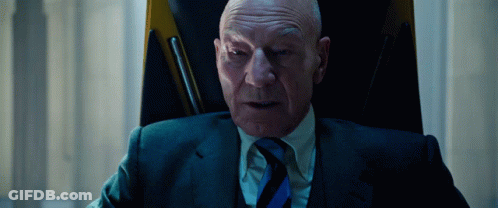 Man In Suit And Tie Sitting In Chair GIF