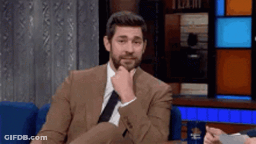 Man In Suit And Tie Sitting In Chair GIF