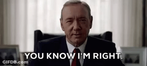 Man In Suit And Tie Sitting In Chair GIF