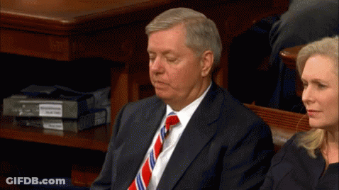 Man In Suit And Tie Sitting In Front Of Woman GIF
