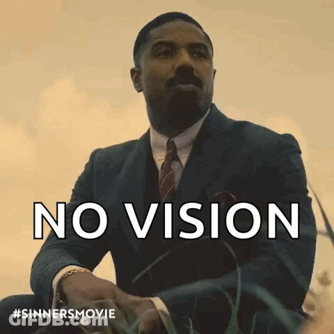 Man In Suit And Tie Sitting In Grass No Vision GIF