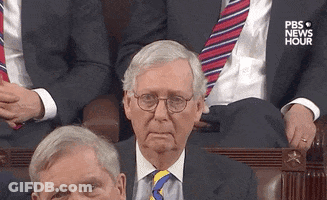 Man In Suit And Tie Sitting In Parliament GIF