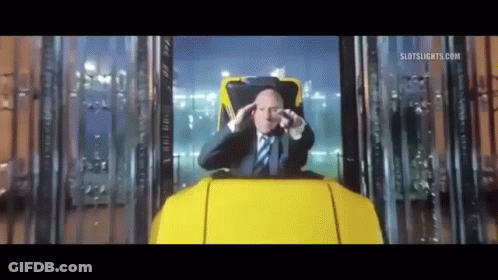 Man In Suit And Tie Sitting In Roller Coaster GIF