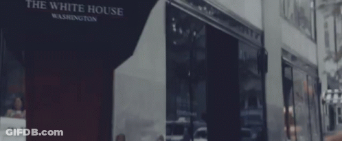 Man In Suit And Tie Sitting In Room GIF