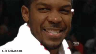 Man In Suit And Tie Sitting In Stadium GIF