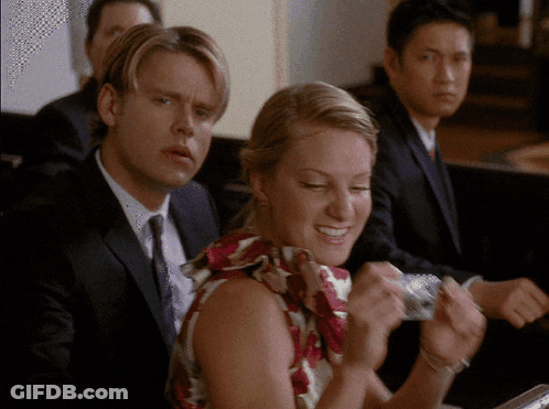 Man In Suit And Tie Sitting Next To Woman GIF