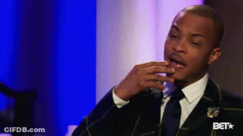 Man In Suit And Tie Sitting On Blue Background GIF