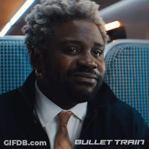 Man In Suit And Tie Sitting On Bullet Train GIF