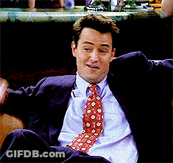 Man In Suit And Tie Sitting On Chair GIF