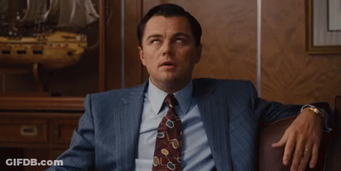 Man In Suit And Tie Sitting On Couch GIF