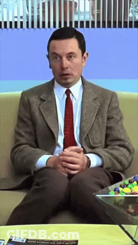 Man In Suit And Tie Sitting On Couch GIF