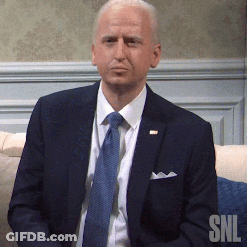 Man In Suit And Tie Sitting On Couch GIF