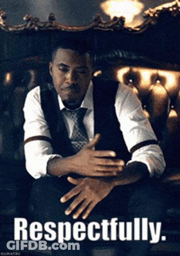 Man In Suit And Tie Sitting On Couch Respectfully GIF