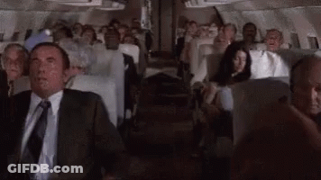 Man In Suit And Tie Sitting On Plane GIF