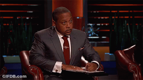 Man In Suit And Tie Sitting On Show GIF