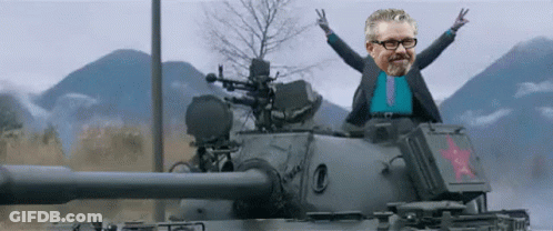 Man In Suit And Tie Sitting On Tank GIF