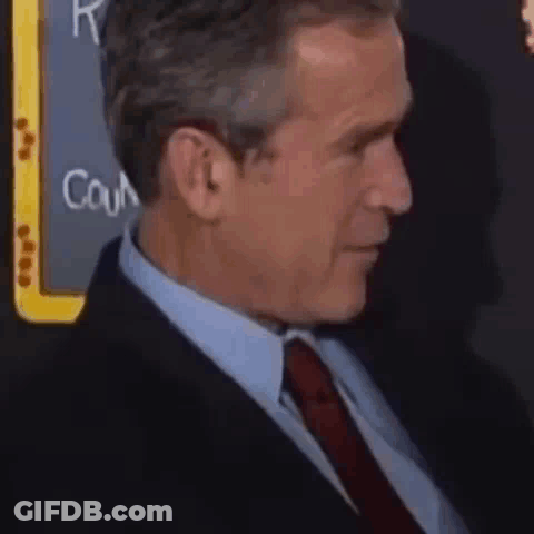 Man In Suit And Tie Sitting GIF