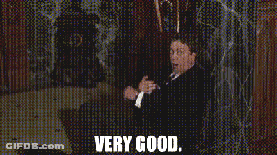 Man In Suit And Tie Sitting Saying Very Good GIF