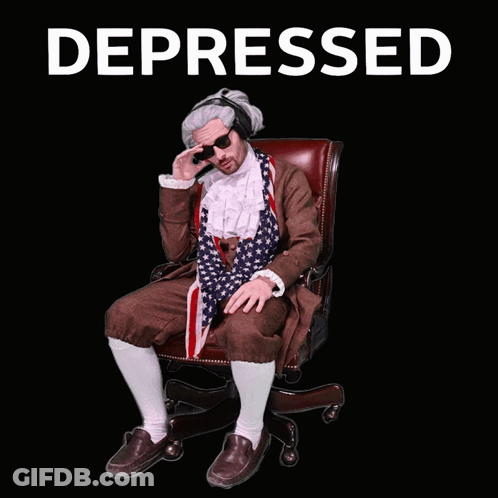 Man In Suit And Tie Sitting With Depressed GIF