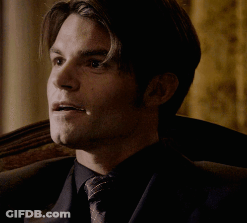 Man In Suit And Tie Sitting With Eyes Closed GIF