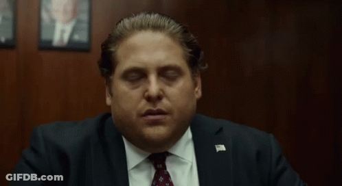 Man In Suit And Tie Sitting With Eyes Closed GIF