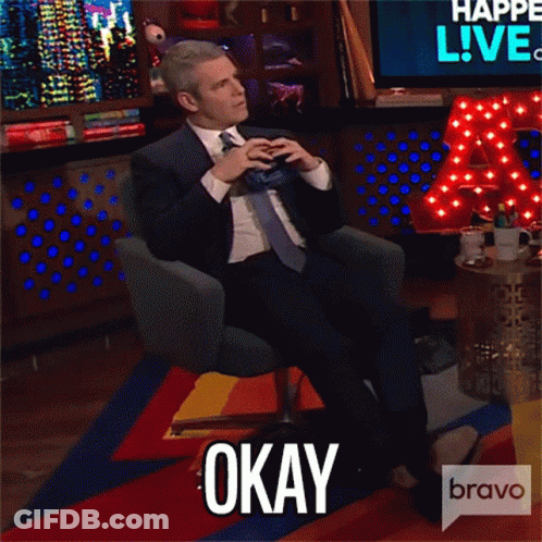 Man In Suit And Tie Sitting With Feet Up And Okay Text GIF
