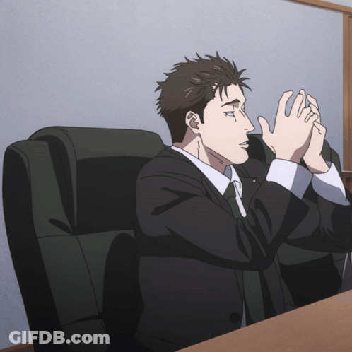 Man In Suit And Tie Sitting With Hands Folded GIF