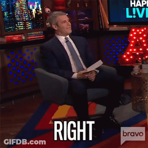 Man In Suit And Tie Sitting With Speech Bubble Saying Right GIF