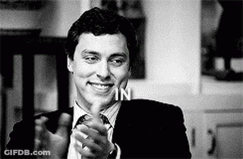 Man In Suit And Tie Smiling And Clapping GIF