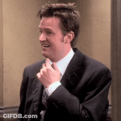 Man In Suit And Tie Smiling And Fixing Tie GIF