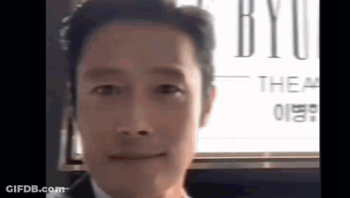 Man In Suit And Tie Smiling At Camera GIF