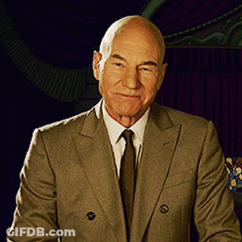 Man In Suit And Tie Smiling At Camera GIF