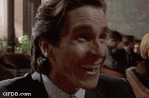 Man In Suit And Tie Smiling At Camera GIF
