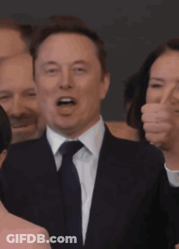 Man In Suit And Tie Smiling At Crowd GIF