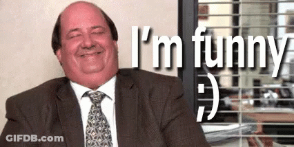 Man In Suit And Tie Smiling At Desk GIF