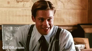 Man In Suit And Tie Smiling At Desk GIF