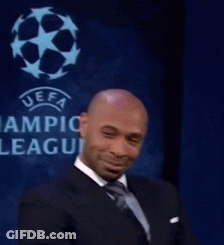 Man In Suit And Tie Smiling At UEFA League Sign GIF