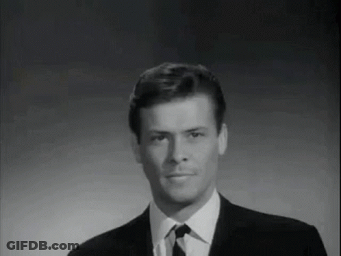 Man In Suit And Tie Smiling Black And White GIF