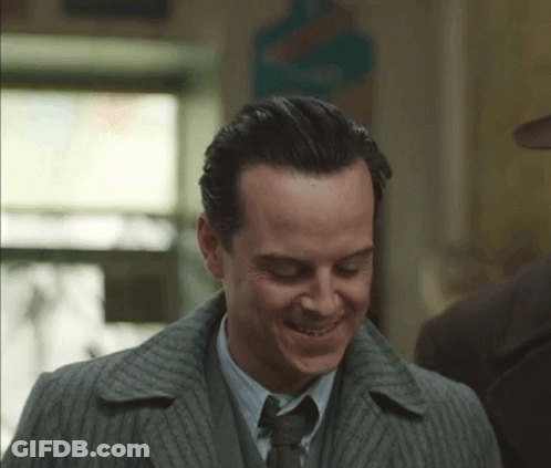 Man In Suit And Tie Smiling Down GIF