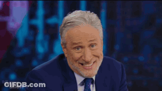 Man In Suit And Tie Smiling Funny Face Daily Show GIF