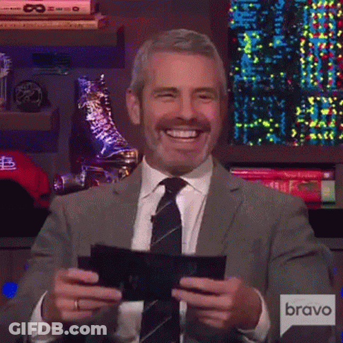 Man In Suit And Tie Smiling Holding Paper GIF