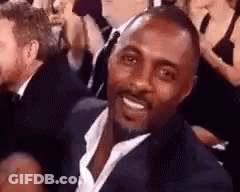 Man In Suit And Tie Smiling In Crowd GIF