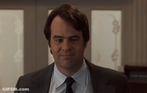 Man In Suit And Tie Smiling In Front Of Window GIF