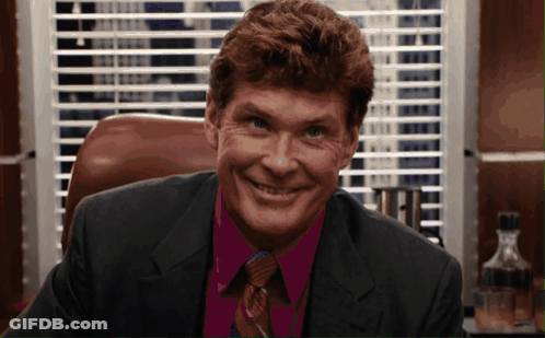 Man In Suit And Tie Smiling In Front Of Window GIF