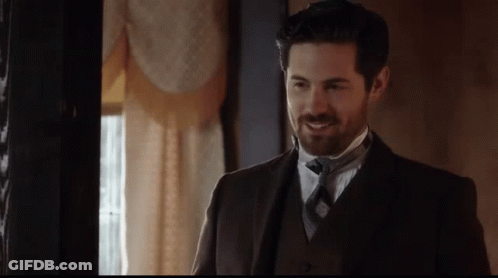Man In Suit And Tie Smiling In Room GIF