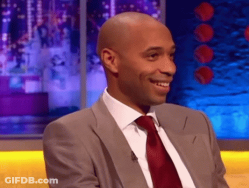 Man In Suit And Tie Smiling On Stage GIF